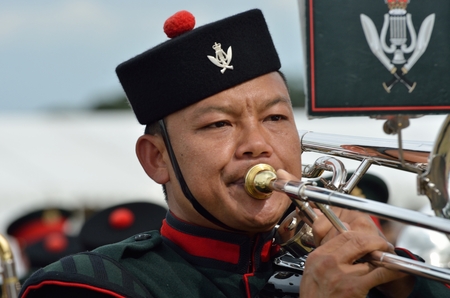 Military Tattoo  COLCHESTER ESSEX UK 8 July 2014:   Gurkha soldier blowing trumpet