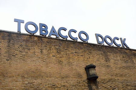WAPPING LONDON UK  Tobacco Dock sign over brick September 2014のeditorial素材
