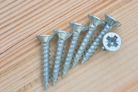 group of screws on woodの写真素材