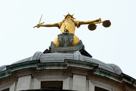 Looking up at justice statue old baileyの写真素材