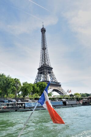 PARIS FRANCE 8 JUNE 2015: Eiffel tower from boat on Seine with flagのeditorial素材