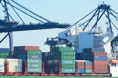 PORT OF FELIXSTOWE SUFFOLK UK  24 FEBRUARY 2016: Large Containers on deck of Ship  with cranes in backgroundのeditorial素材
