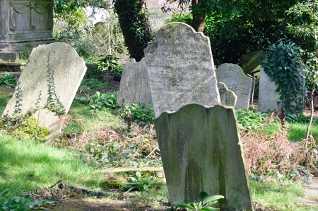 Sloping tombstones in ancient English graveyardの写真素材