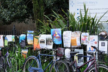 Cambridge England, United Kingdom -May 20, 2016: Posters and Bikes by railings in Cambridge Ukのeditorial素材