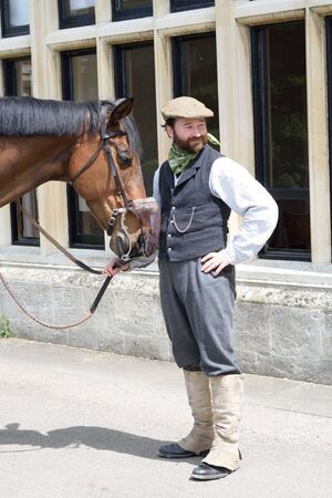 Audley End England, United Kingdom -May 22, 2016: Man with horse in historical clothingのeditorial素材