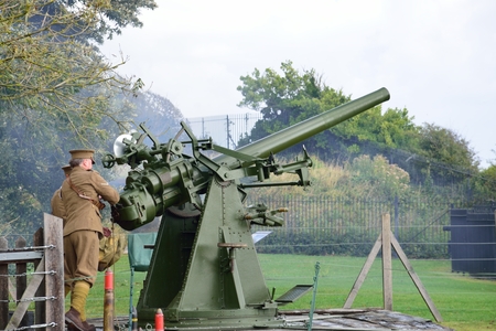 Dover, United Kingdom - October 1, 2016: Man firing world war two  anti aircraft gun in re-enactment