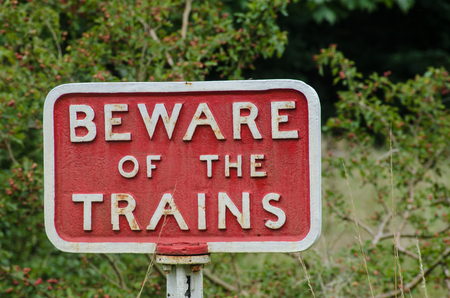 Old fashioned cast iron Beware of Trains signの写真素材