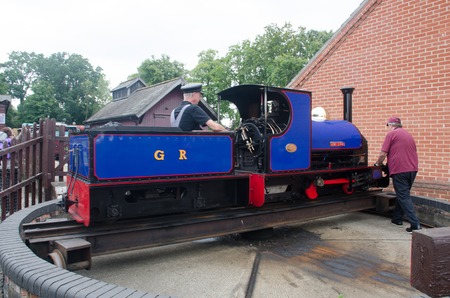 Bressingham Norfolk  United Kingdom   August  21 2017: Blue narrow gauge railway train being pushed  on turntableのeditorial素材