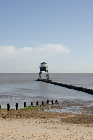Dovercourt Lighthouse on jetty with Beach in Foregroundの写真素材