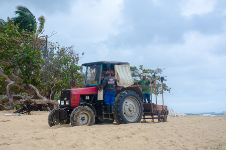 Jibacoa Cuba - 25 January 2018: Tractor on resort beach clearing weedのeditorial素材