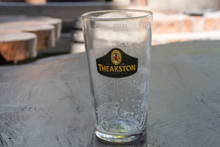 Hull Yorkshire UK  - 27 June 2018:  Empty glass of Theakstons Beer iconic British Aleのeditorial素材