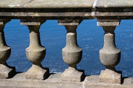 Classical stone railings with pond in backgroundの写真素材