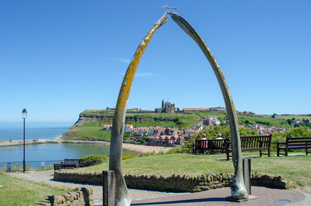 Whitby Yorkshire UK  - 25 June 2018: Looking down on Whitby through Whalebone sculptureのeditorial素材