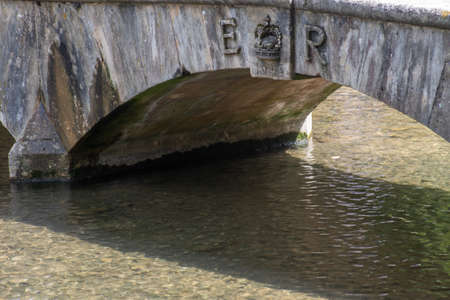 Traditional stone bridge over stream celebrating Queens Coronation
