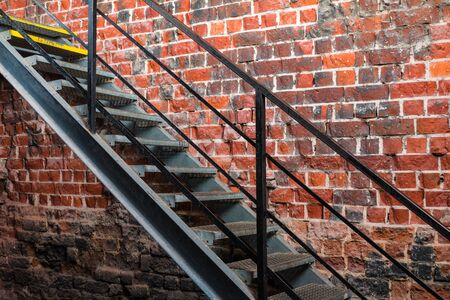 Metal stairway against old brick wallの写真素材
