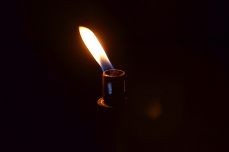 Candle flame at the dark night horizontalの写真素材