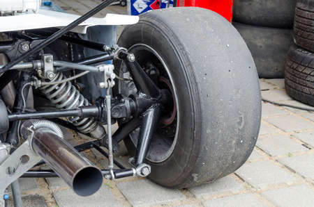 Bolid's wheel and exhaust pipe with smokeの写真素材