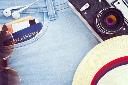 Travel top view background; Tourist's accessories: passport, credit card, money, sunglasses, headphones, camera and hat; Vintage filterの写真素材