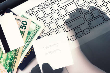 Cyber criminal. Unauthorized access to private data, bank account, money, credit card. Hacker's hands entering stolen password to get access to computer. Security concept. Double exposure. Top view on keyboardの写真素材