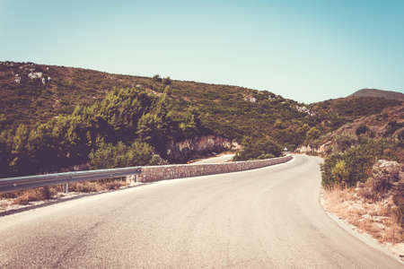 Mountain road. Winding road in the mountains. Vintage filterのeditorial素材
