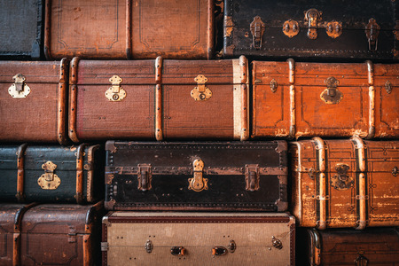 Vintage suitcases stacked in a heap. Traveling concept. Background