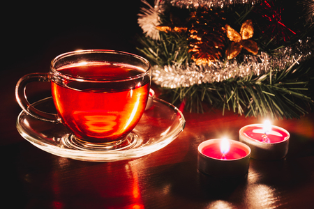 Hot cup of tea near christmas tree. Winter warming drinkの写真素材