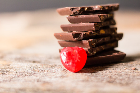 Chocolate Almond and Candy Red, is to be given on Valentine's Day, wooden background