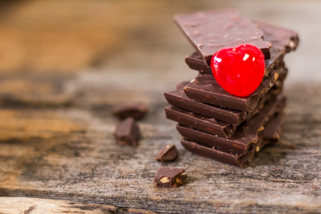 Chocolate Almond and Candy Red, is to be given on Valentine's Day, wooden backgroundの写真素材