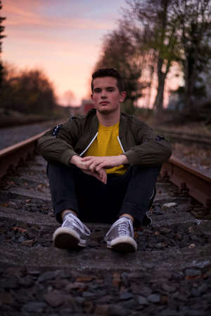 Posing on the railways, at the sunset.の写真素材