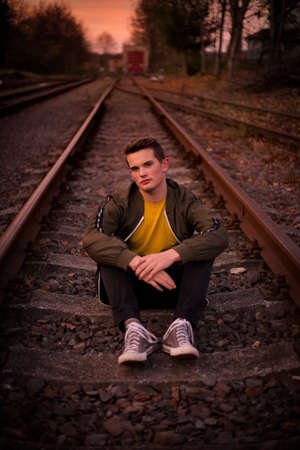 Posing on the railways, at the sunset.の写真素材