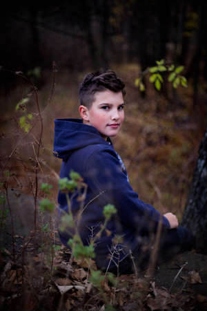A nice boy posing in wild natureの写真素材