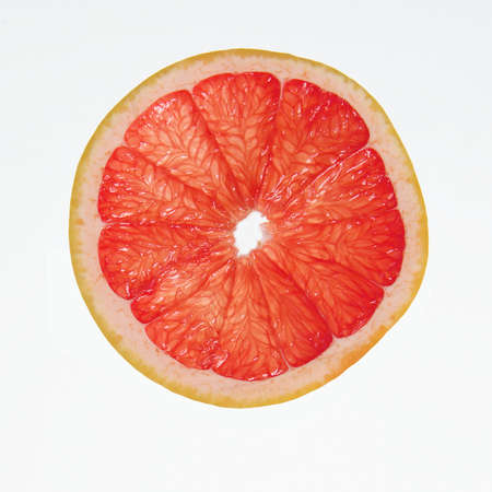 slice of grapefruit isolated on white backgroundの写真素材