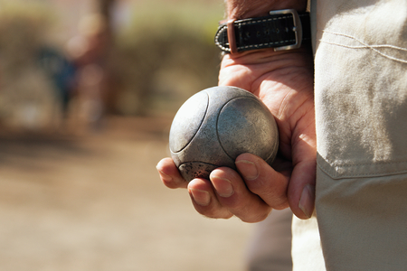 Senior playing petanque,fun and relaxing gameの写真素材