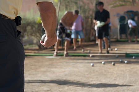 Senior playing petanque, balls on the groundの写真素材