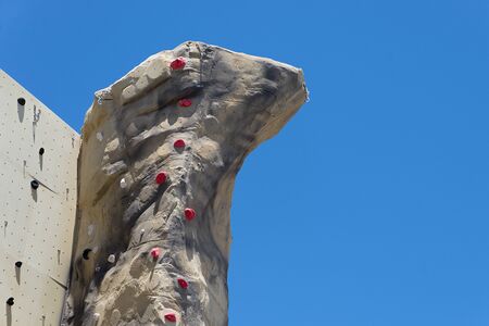 Climbing Tower. This is an image of an artificial climbing tower with a blue sky background.の写真素材