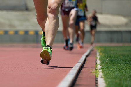 Athletics people running on the track fieldの写真素材