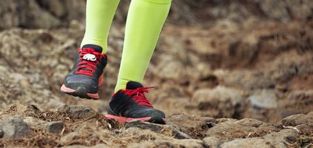 Cross country running feet run through rocky terrain