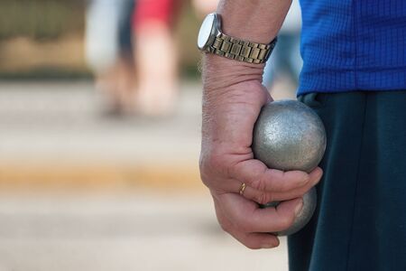 Senior playing petanque,fun and relaxing gameの写真素材