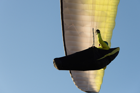 Paraglider flying in a beautiful blue skyの写真素材