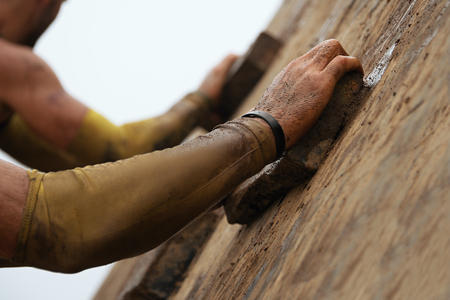 Mud race runners,obstacles during extreme obstacle raceの写真素材