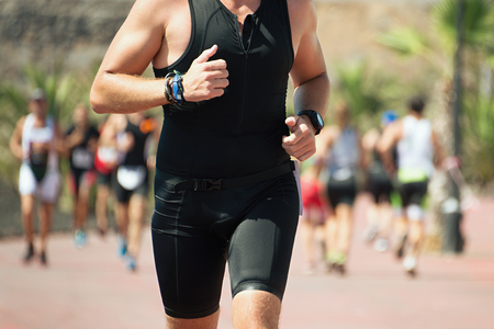 Group of runners in the triathlon event in bright sunlightの写真素材