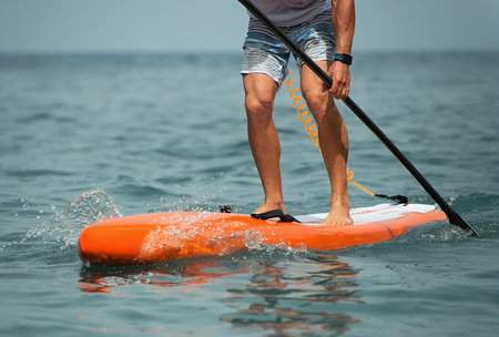 Stand up paddle board man paddleboarding on ocean