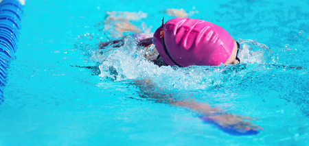 Female swimmer in an outdoor swimming pool,swimmer in blue pool waterの写真素材