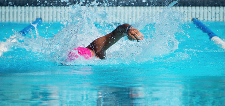 Male swimmer in an outdoor swimming pool,swimmer in blue pool waterの写真素材