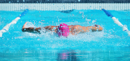 Man swims the butterfly in the poolの写真素材