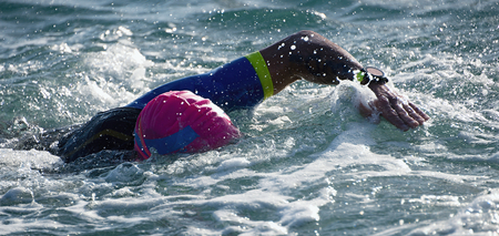 Man swimmer swimming crawl in blue sea,training for triathlonの写真素材