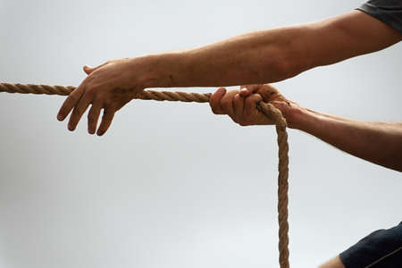 Playing tug of war during obstacleの写真素材