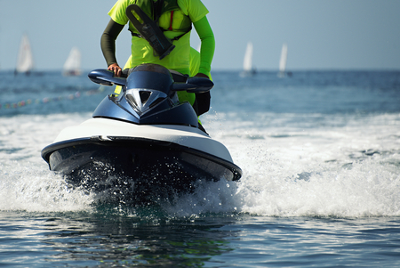 Lifeguard on a jet ski patrols the beach an ocean safety lifeguard riding a jet skiの写真素材