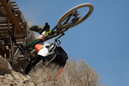 Man falls off his mountain bicycle dramatically,cyclist falls during a raceの写真素材