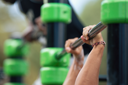 Athletes doing exercise on the horizontal bar,men doing pull ups on street workout outdoors